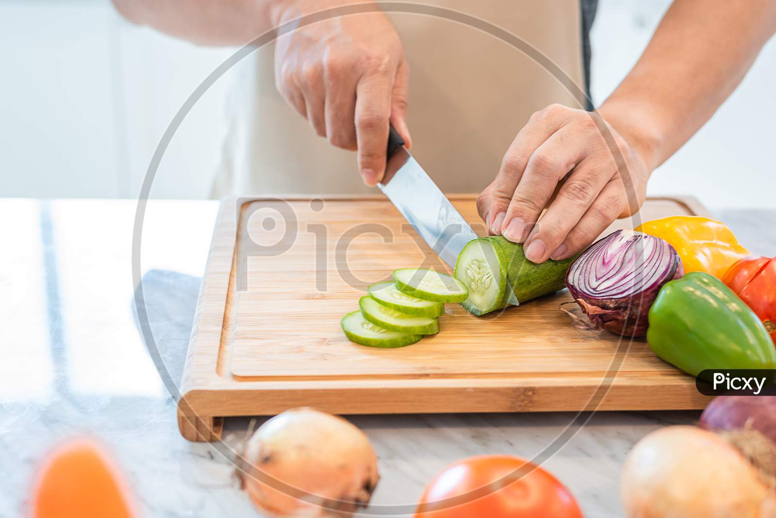 Close Up Of Man Hand Cooking And Slicing Vegetable In The Kitchen For Preparing Dinner With His Wife When Coming Home. People And Lifestyles Concept. Food And Drink Theme.