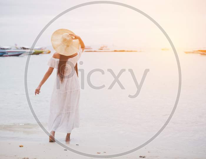 Asian Woman On Beach Enjoying Travel And Fresh Air In Holidays. Vacation And Outdoors Concept. People And Nature Concept. Asian Beauty And Sea Theme.
