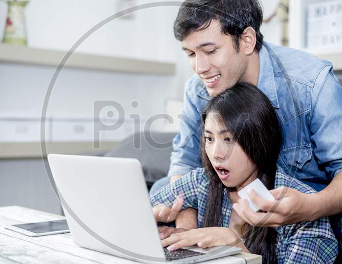 Lover Are Surprising When Using The Laptop. Family Concept, Lovers Concept, Technology Concept