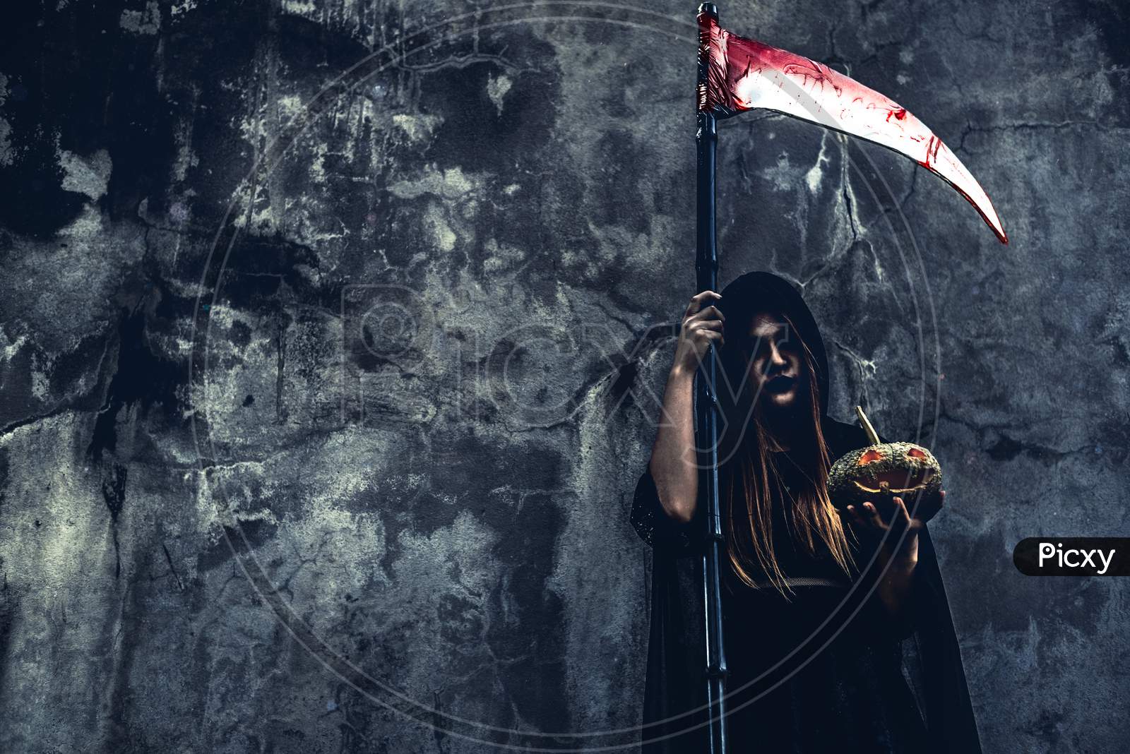 Demon Witch With Reaper On Grunge Wall Background. Halloween And Religious Concept. Demon Angel And Satan Theme.