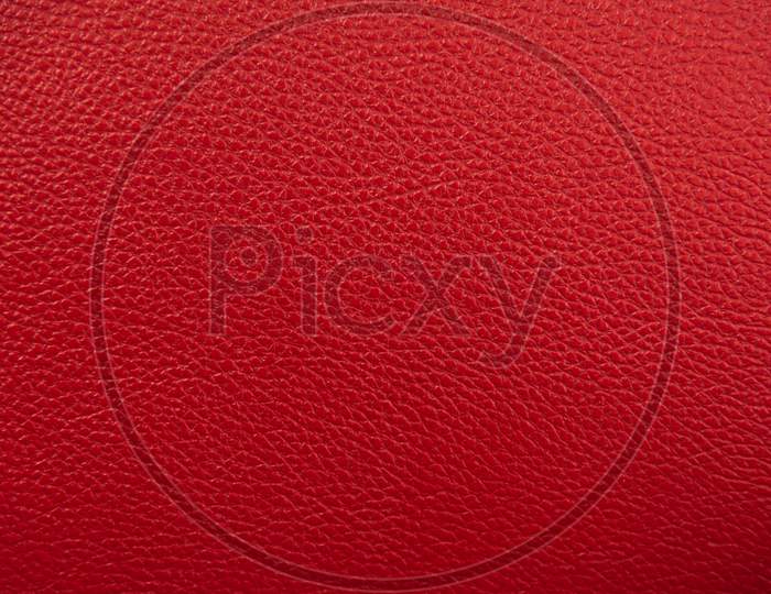 Red Leather Texture Background. Luxury Genuine Textile Surface Material Wallpaper With Furniture Backdrop. Close Up Of Fashion Fabric