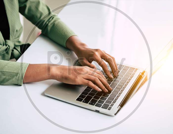 Closeup Of Woman Hand Working At Home Office And Typing On Keyboard. Business And Technology Theme. People Lifestyles And Office Occupation Concept. Accounting And Computer Freelance Programming Theme