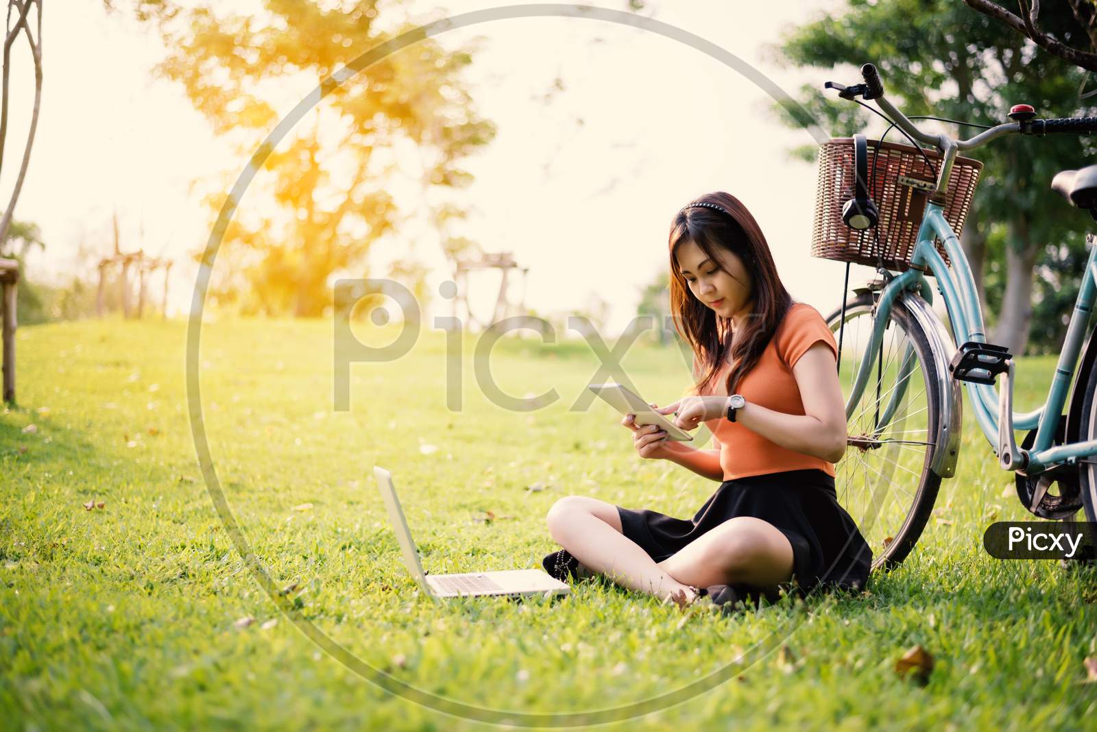 Woman Using The Tablet And Laptop In The Park, Outdoor Concept, Relax Concept, Technology Concept