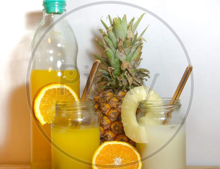 Juices Smoothies And Fresh Pineapple And Orange Drinks With Summer Fruits