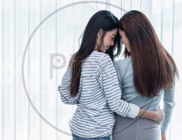 Two Asian Lesbian Women Looking Together In Bedroom. Couple People And Beauty Concept. Happy Lifestyles And Home Sweet Home Theme. Embracing Of Homosexual. Love Scene Making Of Female