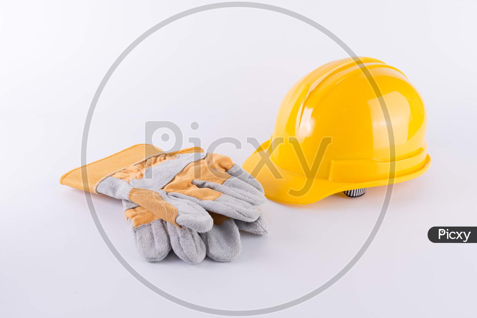 Yellow Safety Helmet And Safety Gloves On White Background. Hard Hat And Thick Gloves On White Isolated Background. Safety Equipment Concept. Worker And Industrial Theme.