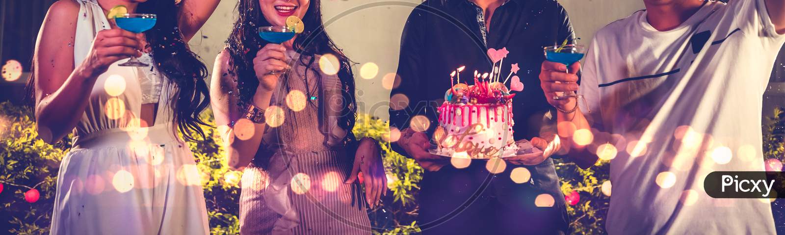 Closeup Lower Body Friends Group Having Outdoor Birthday Party At Night Club With Birthday Cake. Event And Anniversary Concept. People Lifestyles And Friendship Forever In Night Club Banner Background