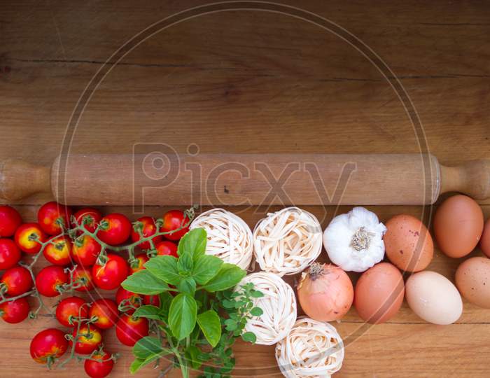 Background Ingredients Kitchen Top View With Noodles Eggs Tomatoes And Fresh Herbs