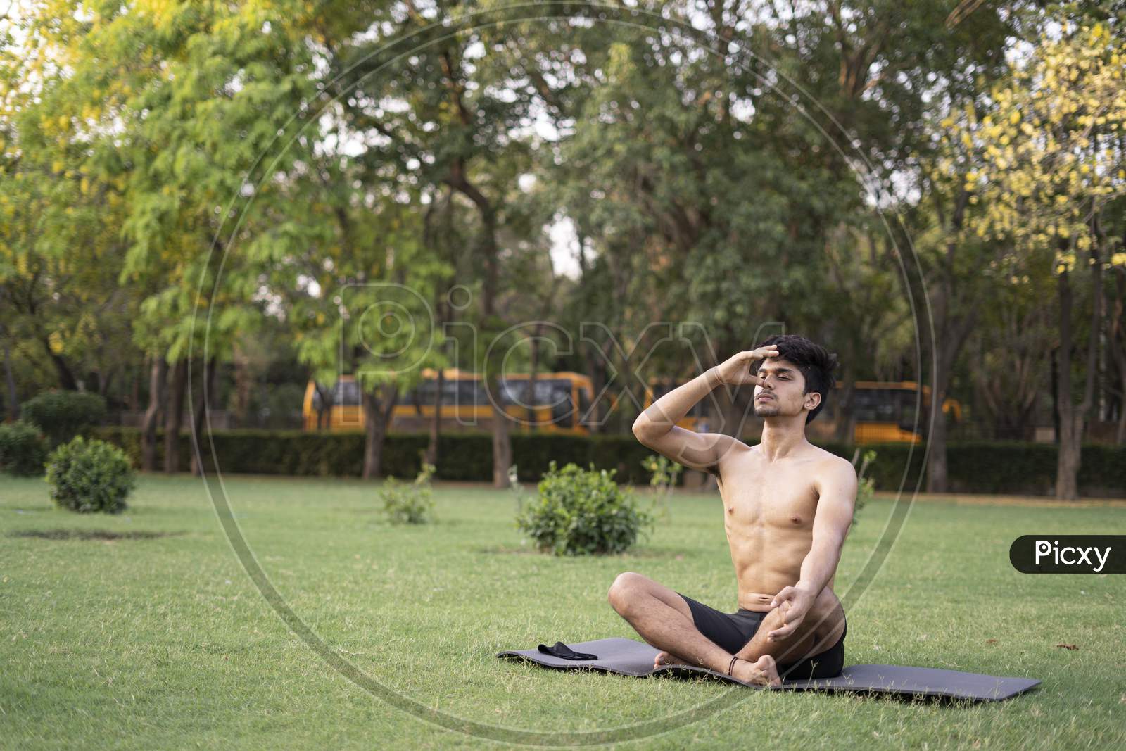 A Young Indian Shredded Teenage Boy Doing Yoga Aasan In The Park On International Yoga Day, Anulom Vilom Aasan.