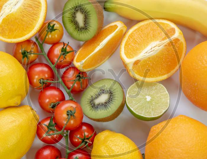 Various Sliced Fruits On White Background. Close Up Of Nutrition Vitamin C Fruits. Healthy And Freshness Food Concept. Top View And Flat Lay Theme.