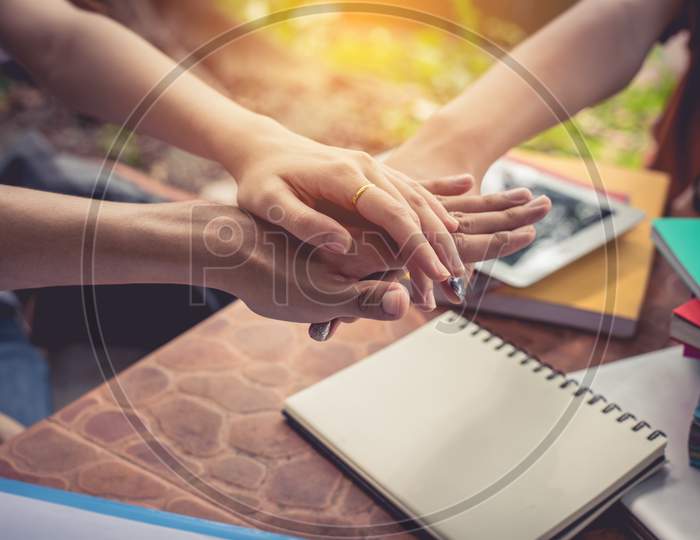 Close Up Hands Of People Putting And Stacking Their Hands Together. Friendship And Unity Concept. Teamwork And Successful Concept. Parts Of Body And Working People Theme. Business And Marketing Theme.