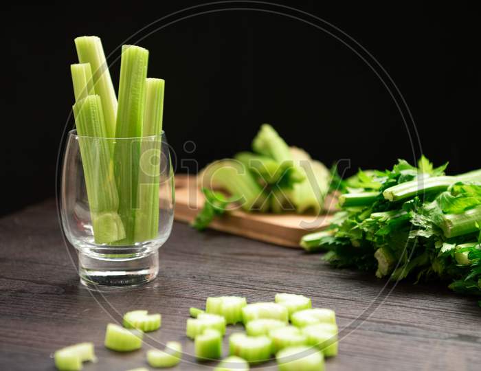 Bunch Of Fresh Celery Stalk On Wooden Table With Leaves Prepared For Making Juice. Food And Ingredients  Of Healthy Vegetable. Freshness Herbal And Low Calories For Dieting With Plenty Of Vitamin