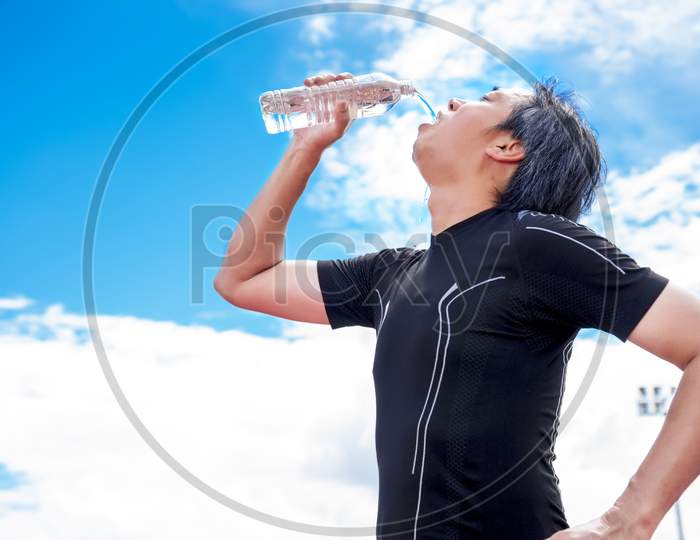 Sportsman Drinking Pure Water When Take Break Or Rest Time, Relax And Sport Concept