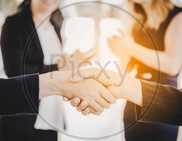Business People Shaking Hands After Finish Reach Agreement For Startup New Project. Negotiating And Happy Working Concept. Handshake Gesturing Connection Deal Concept. People And Teamwork Theme