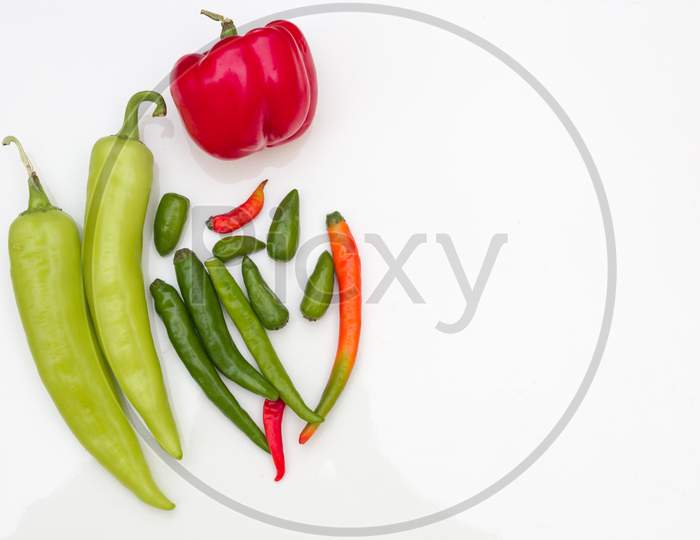 Colorful view of different varieties of hot Indian green chilies .