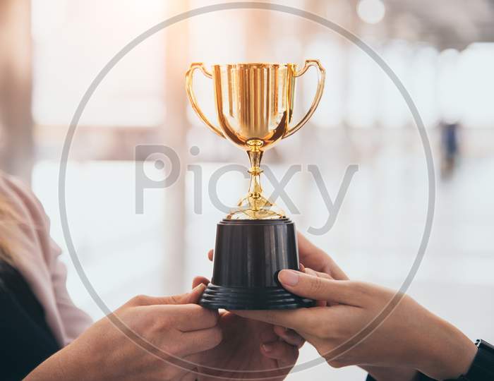 Champion Golden Trophy For Winner Background. Success And Achievement Concept. Sport And Cup Award Theme. Best Business Entrepreneur And Startup Award And Prize. First Place On Final Competition