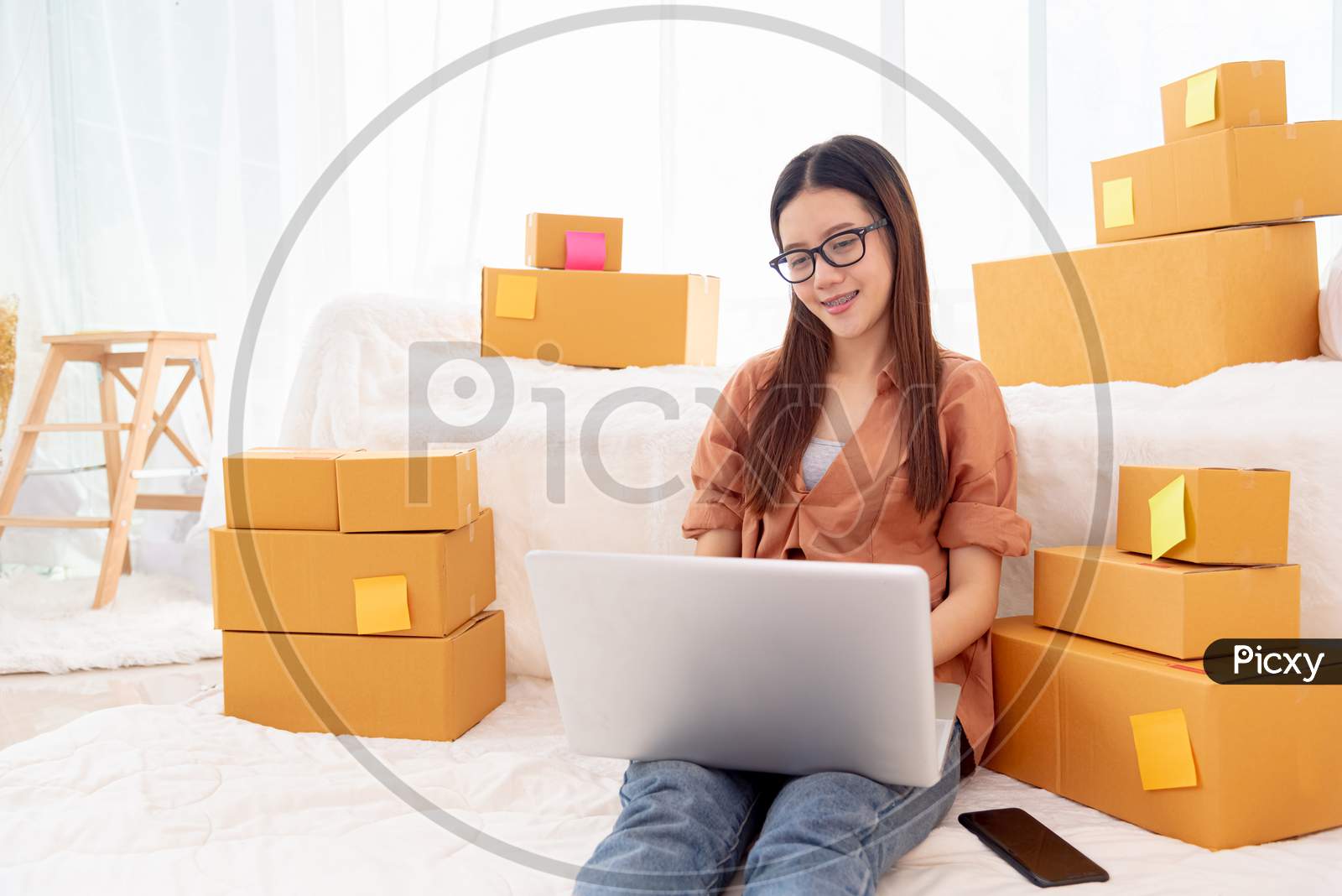 Beauty Asian Woman Using Laptop For Customer Support In Bedroom. Business And Technology Concept. Delivery And Online Shopping Concept. Service Theme. People Lifestyle Remote Work In Domestic House