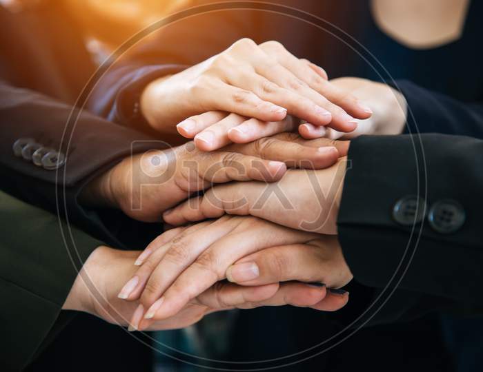 Business People Making Pile Of Hands For Startup New Project. Business And Togetherness Concept. Cooperation And Successful Concept. Teamwork And Organization Theme. Close Up View Of Stacking Hands.
