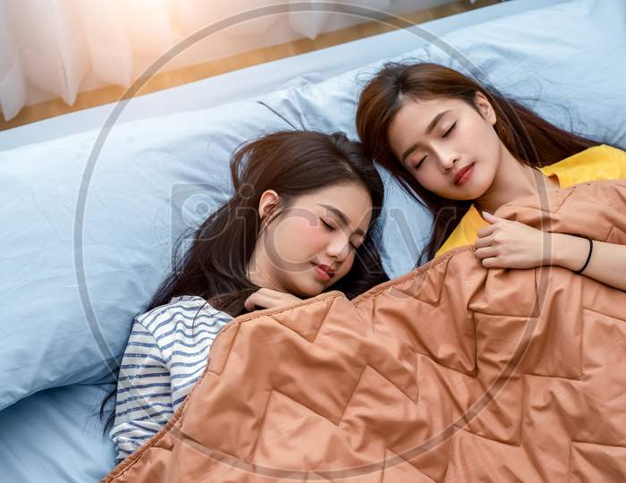 Cute Asian Couple Women Sleeping On Bed Together. Lifestyles And Lovers Concept. Happiness Life And Relax Concept. Homosexual And Friendship Theme. Lgbt Pride And Lesbian Theme.