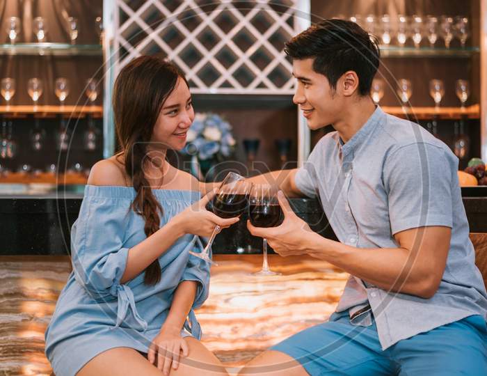 Asian Young Couples Clinking Wine Glasses At Domestic Bar Of Luxury House. Lovers And Couples Concept. Honeymoon And Wedding Theme. Interior And Dating Theme.