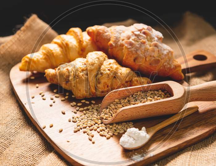 Different Kinds Of Bread With Nutrition Whole Grains On Wooden Background. Food And Bakery In Kitchen Concept. Delicious Breakfast Gouemet And Meal. Carbohydrate Organic Food Cuisine Homemade