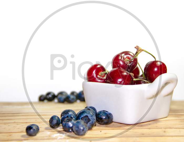 Red Fruits With Rustic Wood Background