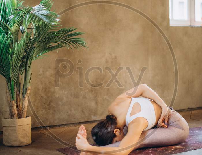 Woman Practicing Yoga at Home