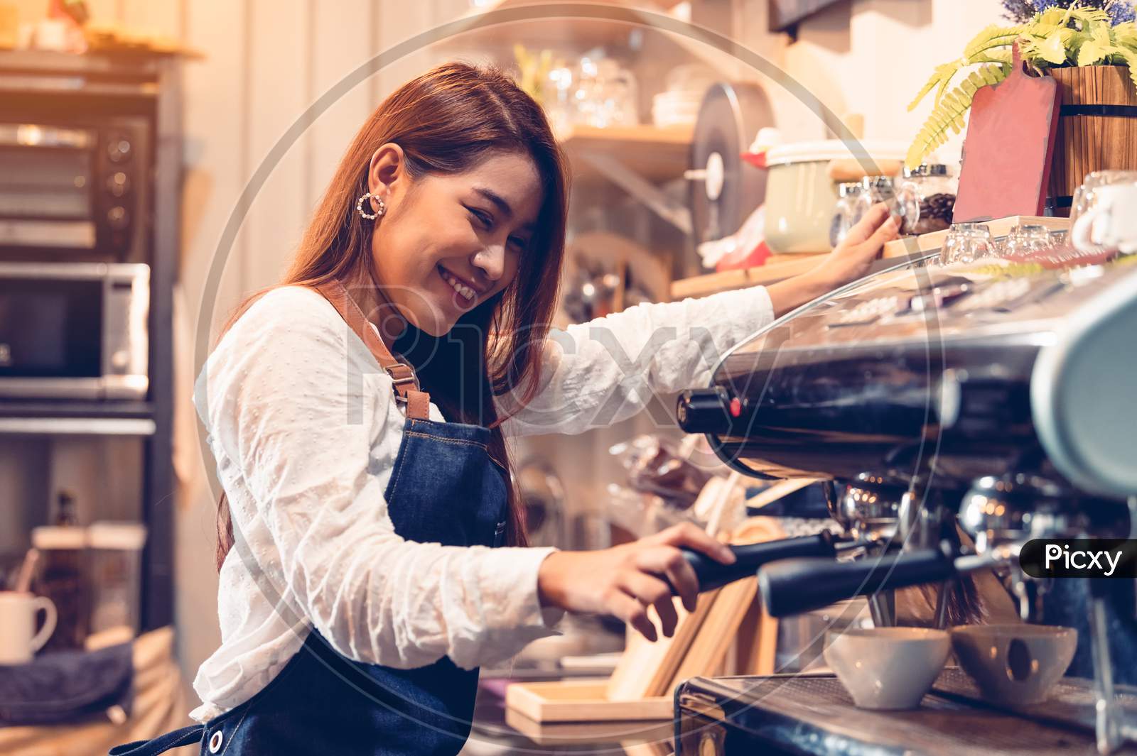 Professional Female Barista Hand Making Cup Of Coffee With Coffee Maker Machine In Restaurant Pub Or Coffee Shop. People And Lifestyles. Business Food And Drink Concept.  Happy Shop Owner Entrepreneur