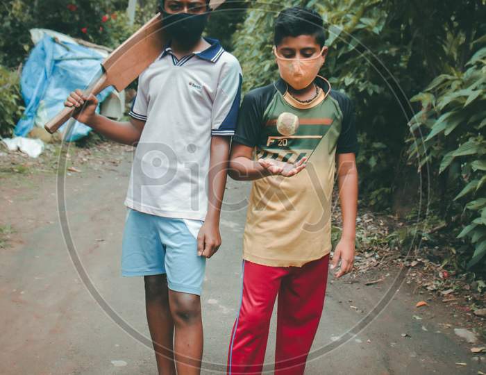 two boys ready to play wearing mask