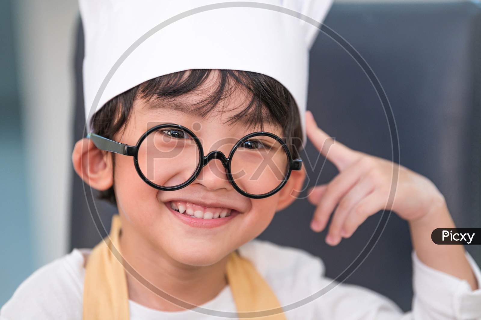 Portrait Cute Little Asian Happiness Boy Interested In Cooking With Mother Funny In Home Kitchen. People Lifestyles And Family. Homemade Food And Ingredients Concept. Baking Christmas Cake And Cookies