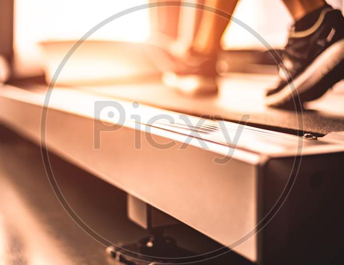 Close Up Of Woman Legs Jogging On Treadmill With Sportswear And Sneakers. Sport And Workout Concept. People And Leisure Concept. Healthcare And Lifestyles Theme. Copy Space For Text On Treadmill.