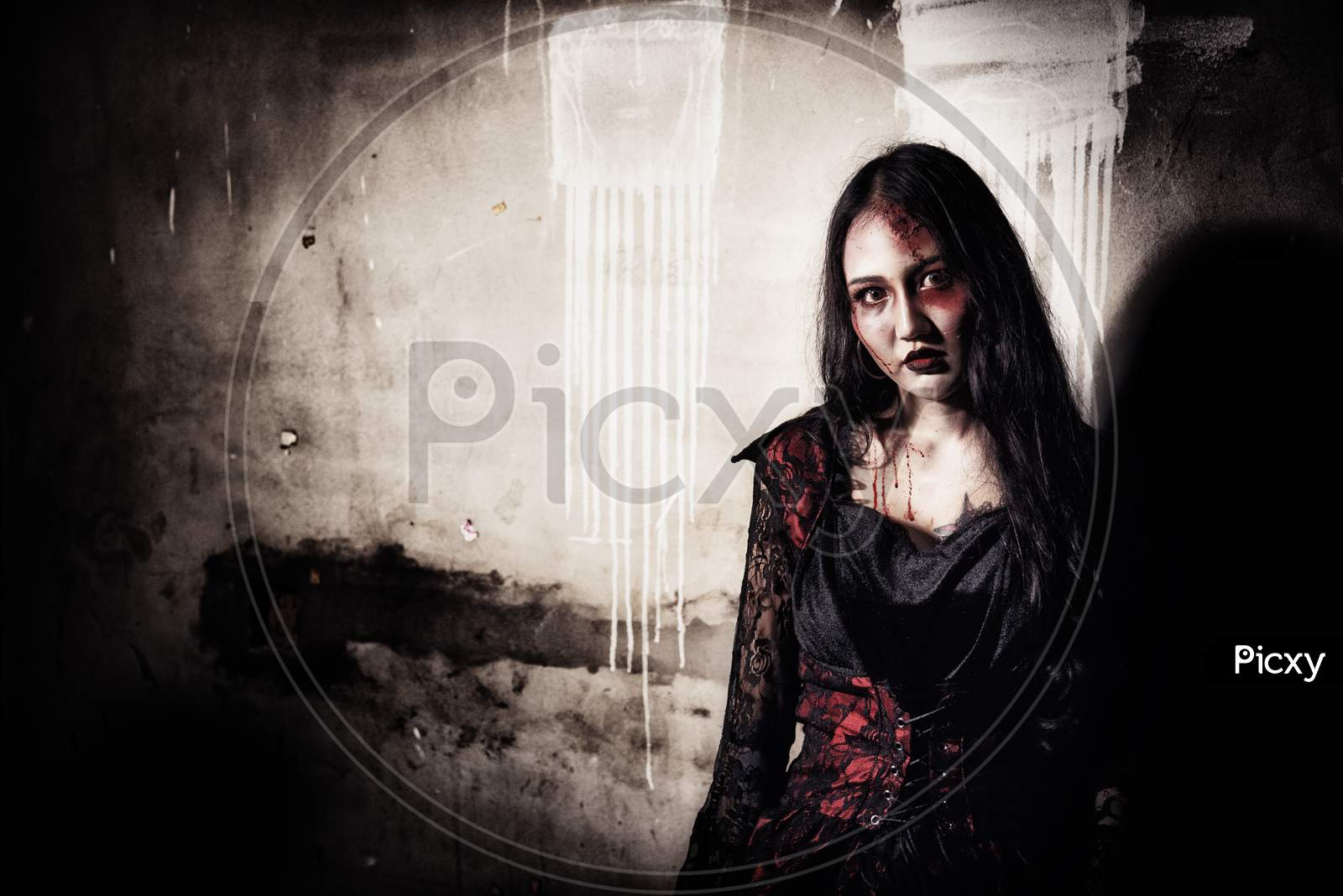 Female Zombie Corpse Standing In Front Of Grunge Wall In Abandoned House. Horror And Ghost Concept. Halloween Day Festival And Scary Movie Theme. Haunted House Theme. Dark Tone Film