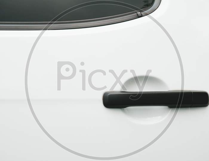 Black Car Door Handle On White Background. Automobile And Texture Concept. Automotive Industry And Safety Lock And Remote Key Accessories Concept. Vehicle Part Unlock Theme