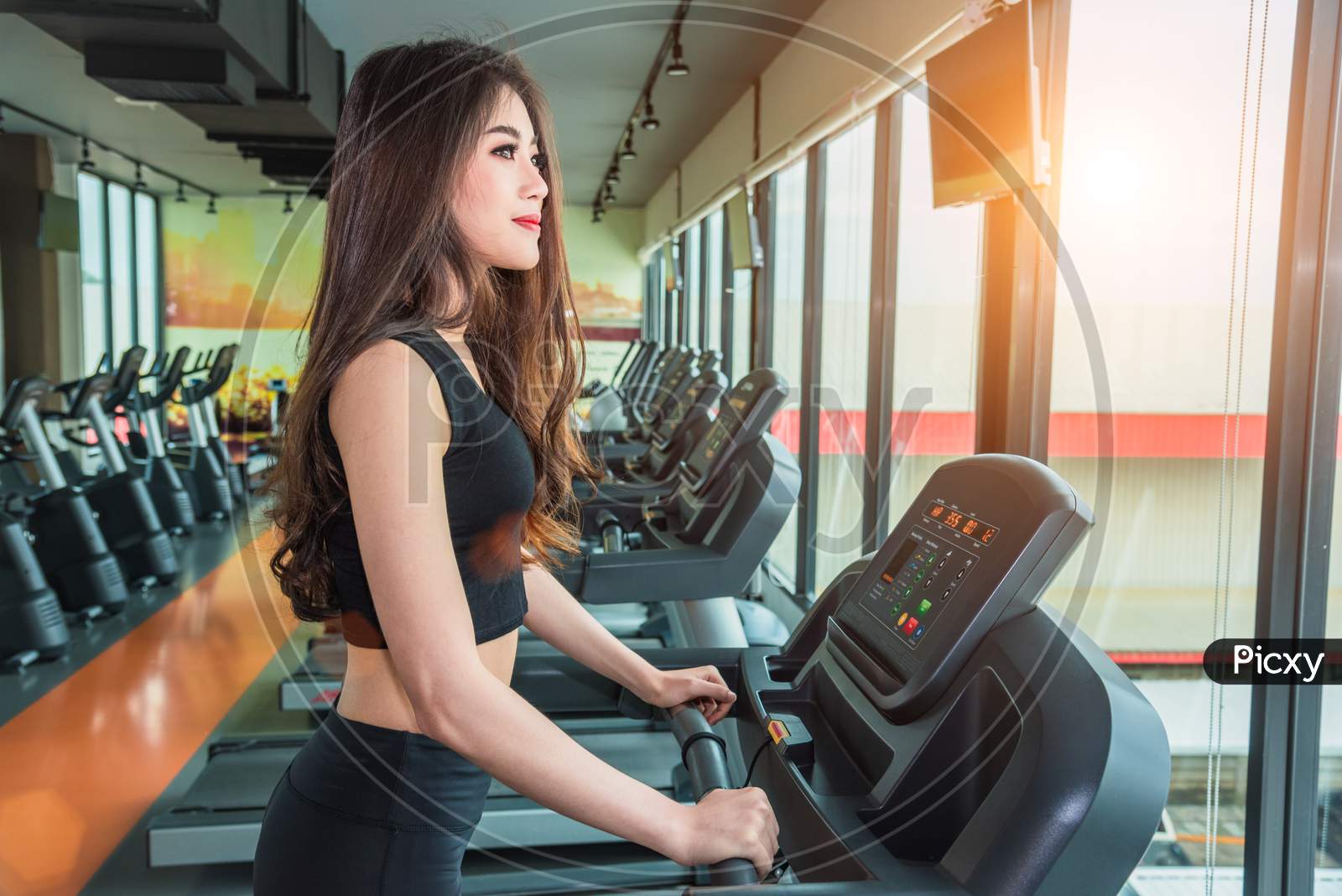 Asian Sport Woman Walking Or Running On Treadmill Equipment In Fitness Workout Gym. Sport And Beauty Concept. Workout And Strength Training Theme. Cardio And Diet Theme