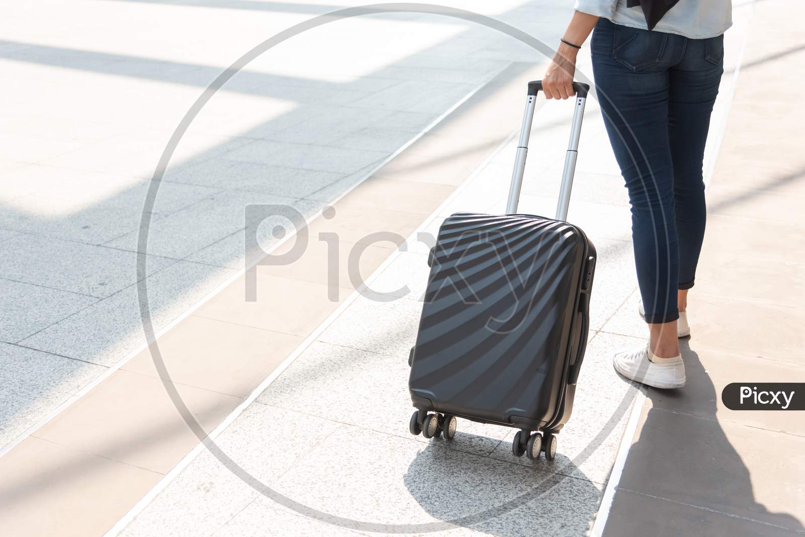 Close Up Woman And Suitcase Trolley Luggage In Airport. People And Lifestyles Concept. Travel And Business Trip Theme. Woman Wear Jeans Going On Tour And Traveling Around The World By Alone Solo Girl