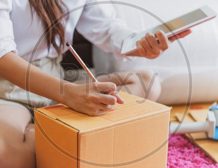 Closeup Of Asian Business Woman Hand Startup Small Business Entrepreneur Sme Distribution Warehouse With Parcel Mail Box. Small Owner Home Office. Online Marketing And Product Packaging And Delivery