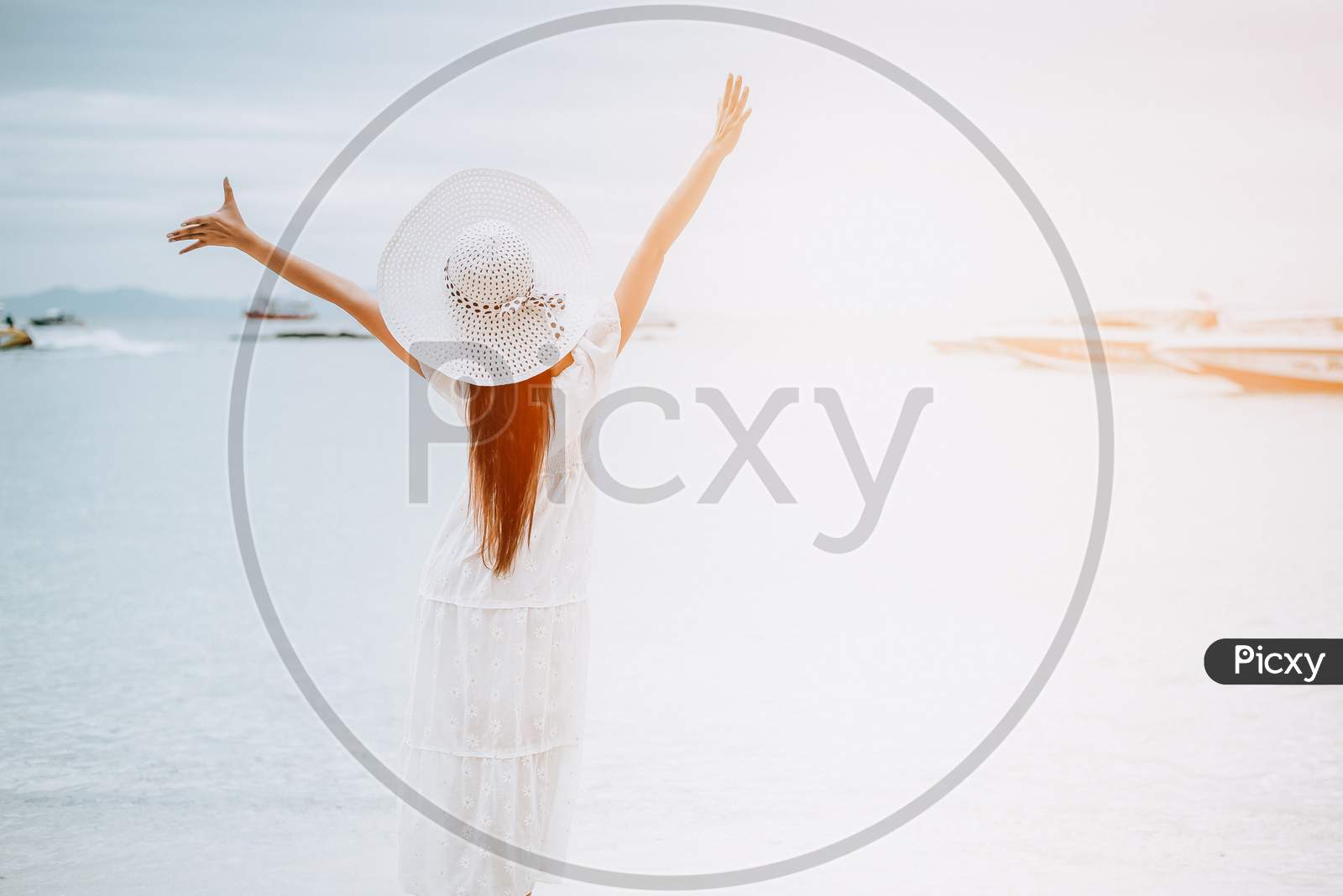 Asian Woman On Beach Enjoying Travel And Fresh Air In Holidays. Vacation And Outdoors Concept. People And Nature Concept. Asian Beauty And Sea Theme.