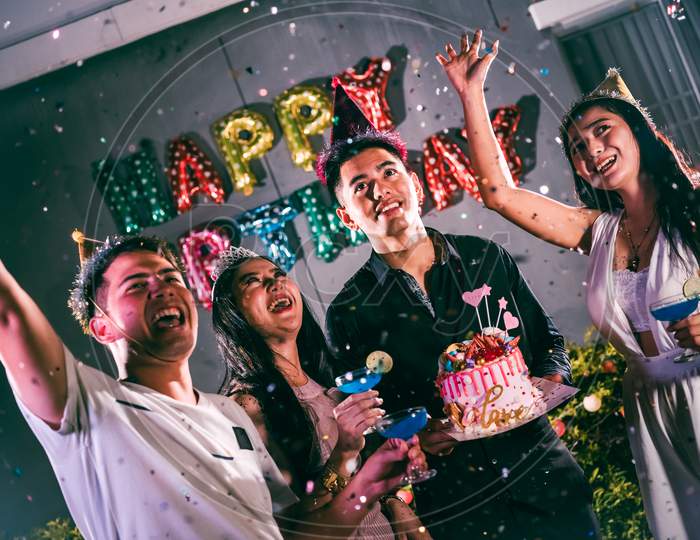 Asian Friends Having Fun In Birthday Party At Night Club With Birthday Cake. Event And Anniversary Concept. People Lifestyles And Friendship.