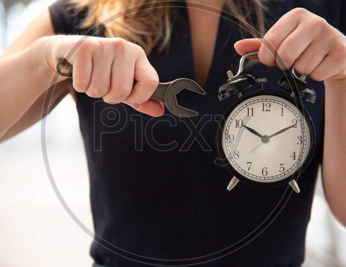 Business Woman Try To Adjust Time On Alarm Clock After Shocked With Late In Rush Hours When Going To Work In City Urban Background. Deadline And Wake Up Late. People Lifestyle Daily Life Concept.