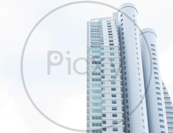 Tall Building With Clear White Sky. Architecture And Structure Concept. People Life And Living Theme.