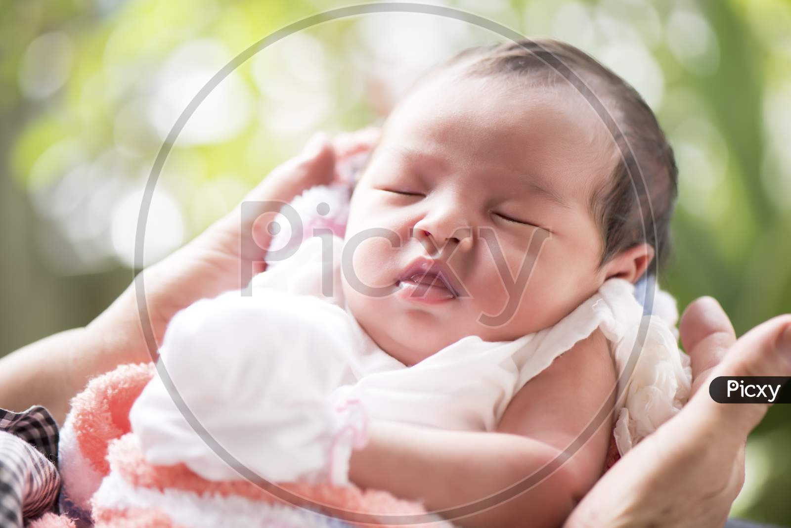 Newborn Baby Sleeping In Mother'S Hands, Selective Focus In Her Eyes, Family Concept