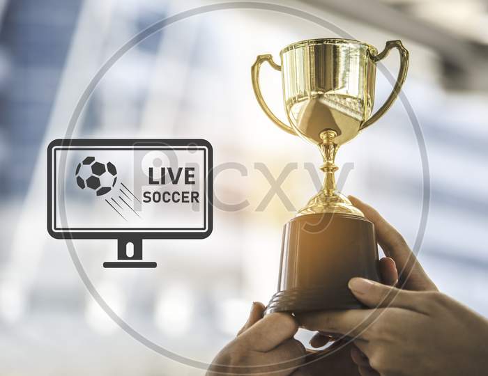 Champion Golden Trophy For Winner Background With Live Soccer Screen Icon On Right. Success And Achievement Concept. Sport And Cup Award Theme. Television Broadcast Theme.