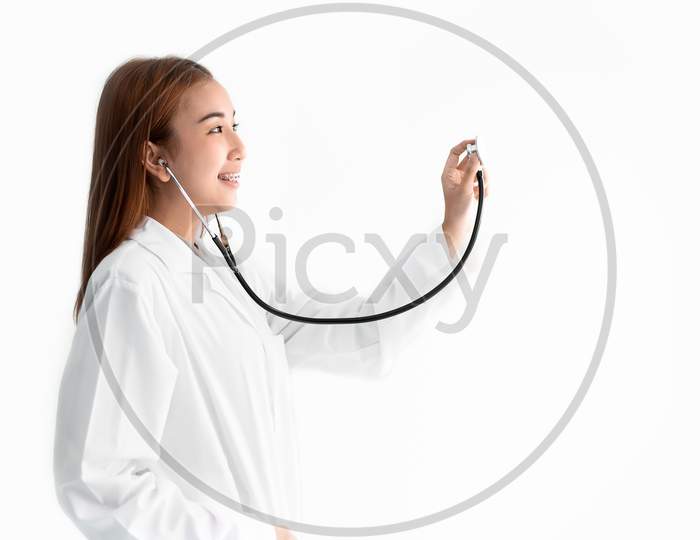 Female Doctor Is Holding Stethoscope And Hear Heart Beat Sound On White Isolated Background. Medical And Healthcare Concept. Hospital And People Theme