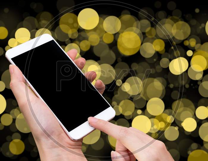 Woman Hold Smart Phone And Touch Button By Hand With Blank Screen For Advertisement, Yellow Bokeh Blur And Abstract Background ,Technology Concept