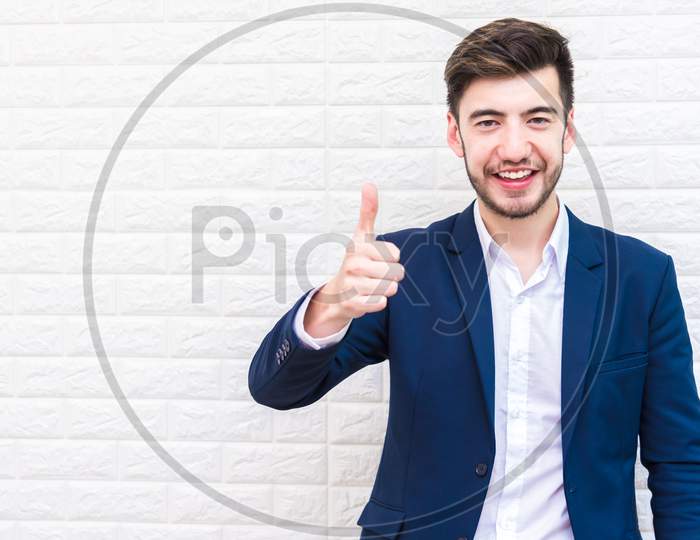 Handsome Businessman Doing Thumbs Up Gesture. Business And Success Concept. People And Portrait Theme.