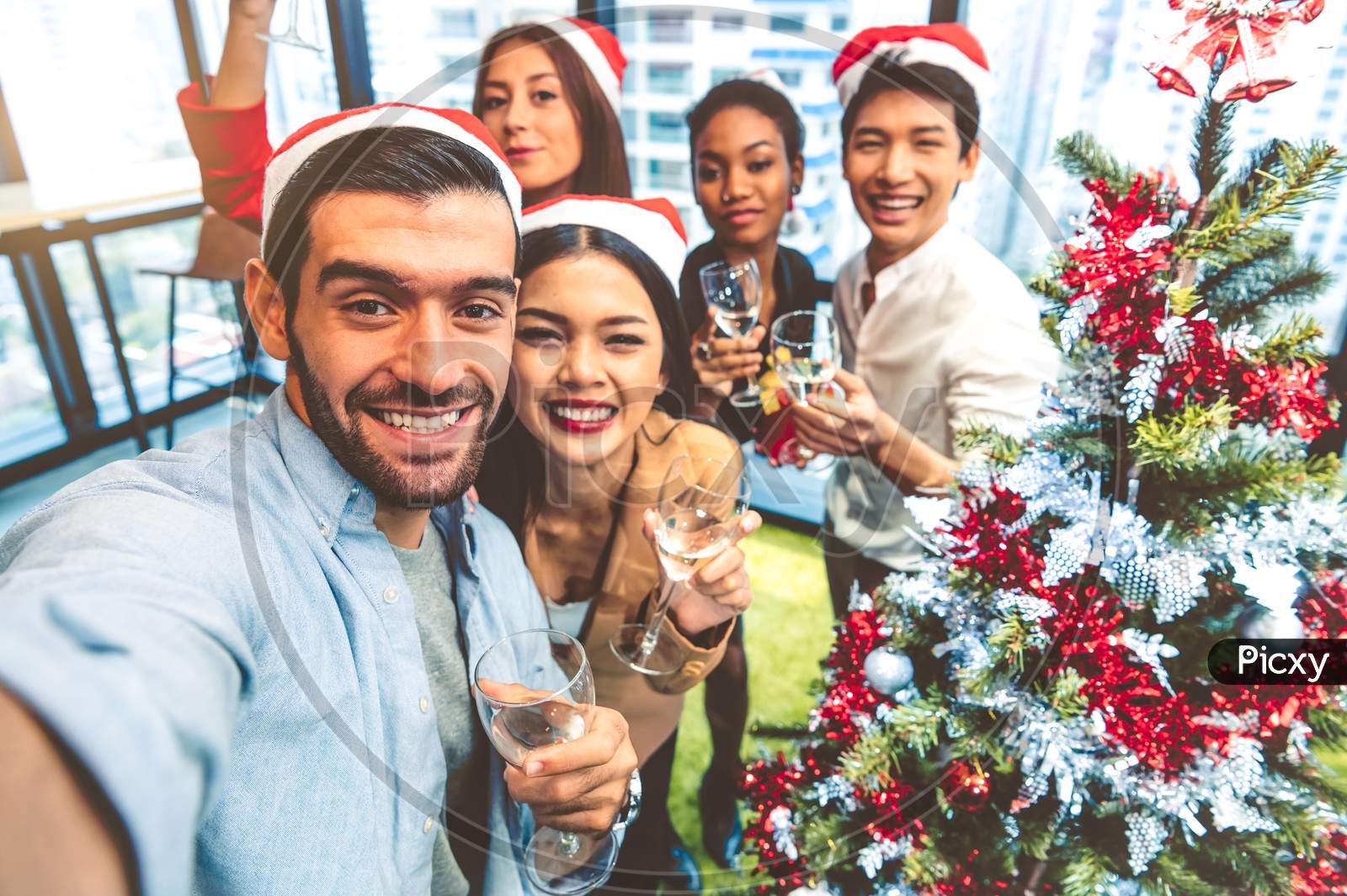 Working People Self Portrait Of Mixed Race Friends Celebrating For Merry Christmas And Happy New Year Party 2020 In Working Office. Multiracial Diversity Young Business Group Selfie By Phone Camera