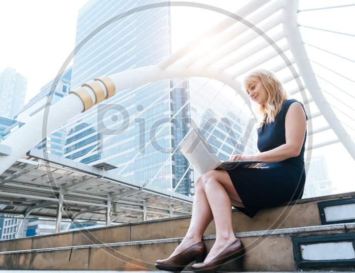 Business Woman Working With Laptop At Outdoors. Technology And Happiness Concept. Beauty And Lifestyle Concept. City And Urban Theme. Blonde Hair Woman Using Computer