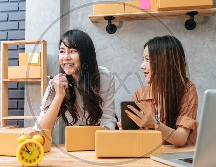 Two Young Asian Women Startup Small Business Entrepreneur Sme Distribution Warehouse With Parcel Mail Box. Small  Owner Home Office. Online Marketing And Product Packaging And Delivery Service