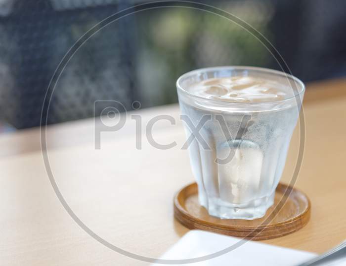 Mineral Water In Glass On Wood Table With Abstract Background, Selective Focus On Stream, Food Drinks And Healthcare Concept