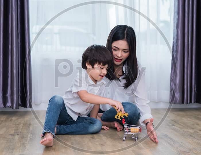 Young Asian Mom And Son Playing Toy In House. Mother And Son Concept. Happy Family And Home Sweet Home Theme. Preschool And Back To School Theme.